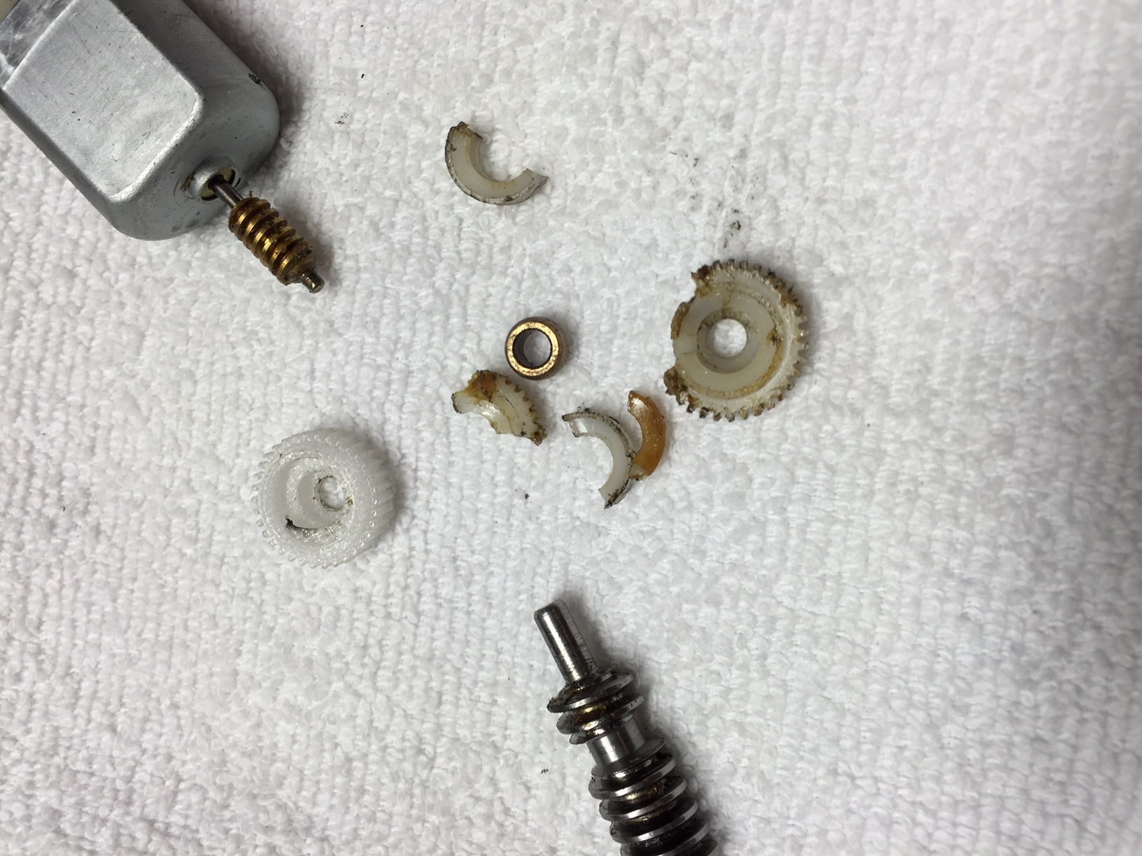 Close-up of the mirror motor and gear housing during disassembly